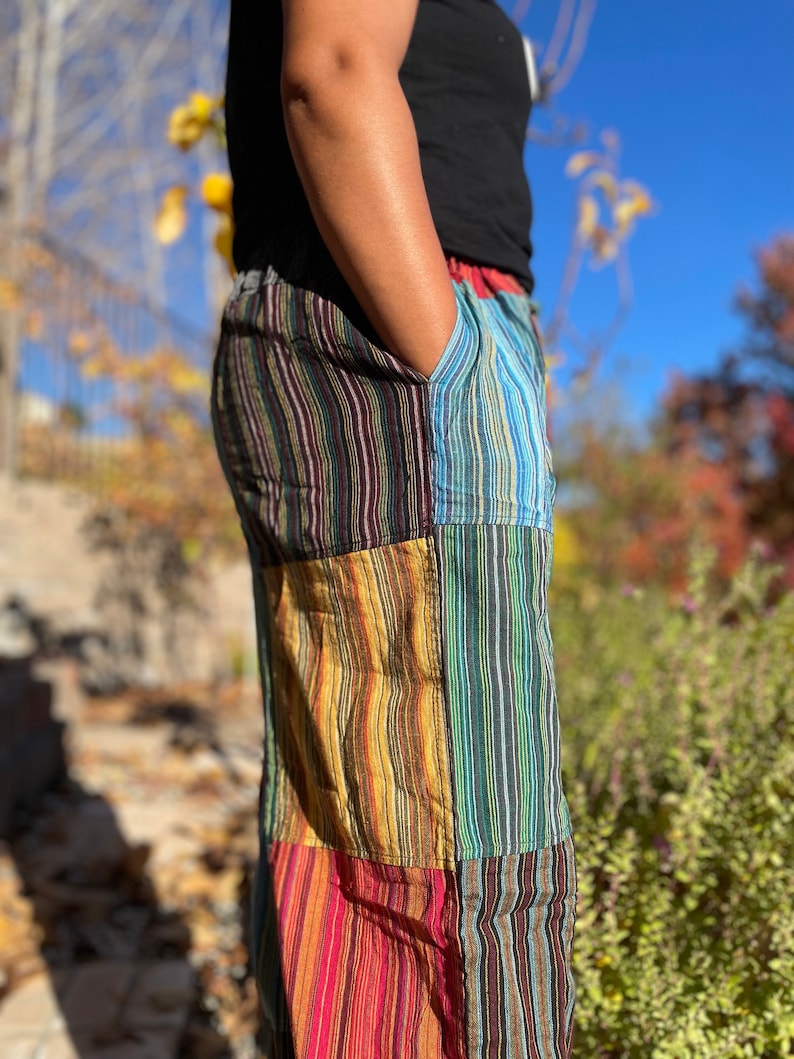 May include: Multicolored striped pants with a patchwork design. The pants are made of a soft, comfortable fabric and have a relaxed fit.