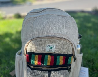 May include: A beige hemp backpack with a black and red striped pocket and a label that reads "Himalayan Hemp Eco-Friendly Made in Nepal".