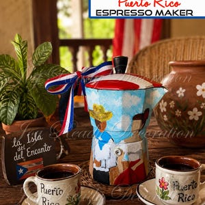 May include: A hand-painted espresso maker featuring a blue sky, clouds, and figures in traditional attire. The lid is red, white, and blue, and a ribbon in the same colors is tied to the handle. Two ceramic cups with Puerto Rico text are included.