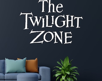 May include: A living room interior with a blue couch, a blue ottoman, and a green plant in a silver pot. The wall is dark blue and has a white vinyl decal that reads "The Twilight Zone".