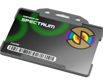 May include: Gray plastic badge holder with a clear front and a black and white barcode. The badge holder has a slot for a lanyard. The badge holder has the text "MEMBER OF SPECTRUM" and a logo with a rainbow circle.
