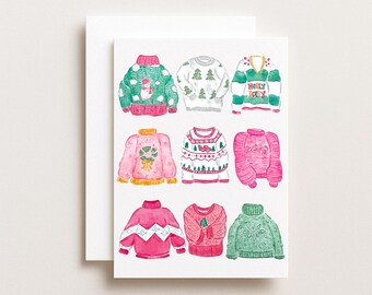 May include: A greeting card featuring watercolor illustrations of nine festive holiday sweaters. The sweaters are in various colors, including green, pink, and red, with designs such as snowmen, Christmas trees, and the words "Holly Jolly."