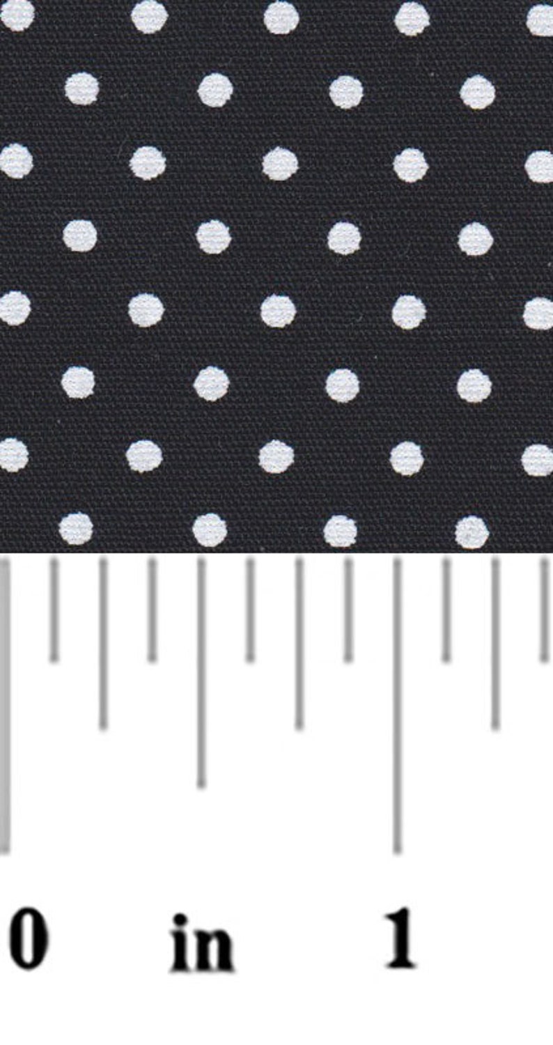 a ruler with white dots on a black background