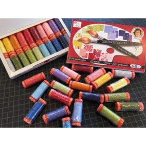 May include: A set of 20 spools of 100% cotton quilting thread in various colors. The spools are arranged in a wooden box and labeled "Quilter's Palette".