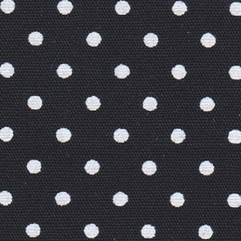 a black tie with white polka dots on it