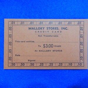 May include: A brown paper credit card for Mallory Stores, Inc. The card entitles the holder to $3.00 credit at Mallory Stores. The card is not transferable.