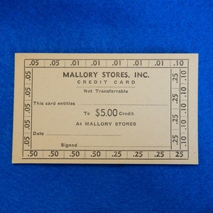 May include: A vintage Mallory Stores, Inc. credit card entitles the holder to $5.00 credit at Mallory Stores. The card is beige with black text and is not transferable.
