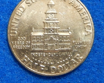 Error Coin: 1976 Bicentennial Kennedy Half Dollar, Missing/Extremely Weak Letters, Capped Die U.S. Mint Error