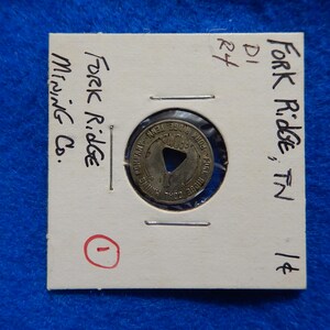 May include: A close-up of a silver token with the text "Fork Ridge Mining Co." and "Fork Ridge, TN 1¢" on a white card with the number "1" circled in red.