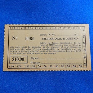 May include: A rectangular tan paper merchandise voucher from Gilliam Coal & Coke Co. in Gilliam, W. Va. The ticket features the number 9090, a value of $10.00, and perforated edges with numerical denominations printed along the top, bottom, and right side.