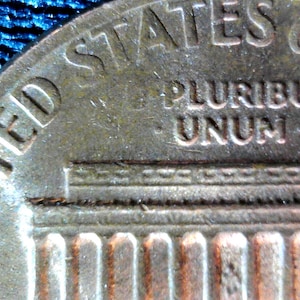 ERROR Coin: 1980-P Lincoln penny/cent Struck Through Grease Error Missing Letter E on Reverse