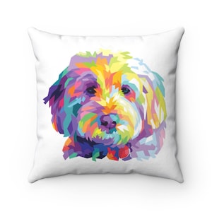 May include: Square white throw pillow featuring a colorful geometric design of a dog's face. The dog's fur is rendered in a mosaic of vibrant colors including yellow, purple, blue, and green. The pillow is a decorative item.