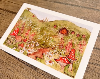 May include: A watercolor painting of a small, red-roofed house nestled into a green hillside. The house has a small, wooden door and a window. The hillside is covered in green grass and wildflowers, including white daisies and red flowers. There are also red and white mushrooms growing in the grass. The painting is signed "Bonnieza."