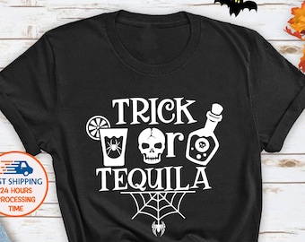 May include: Black t-shirt featuring the text "TRICK OR TEQUILA" in white, accompanied by Halloween-themed illustrations. The design includes a cocktail, skull, potion bottle, and spider web. The shirt is displayed with autumn decorations.
