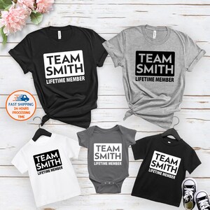 May include: Set of four t-shirts with the text "Team Smith Lifetime Member" in a white square on a black, gray, and white background.