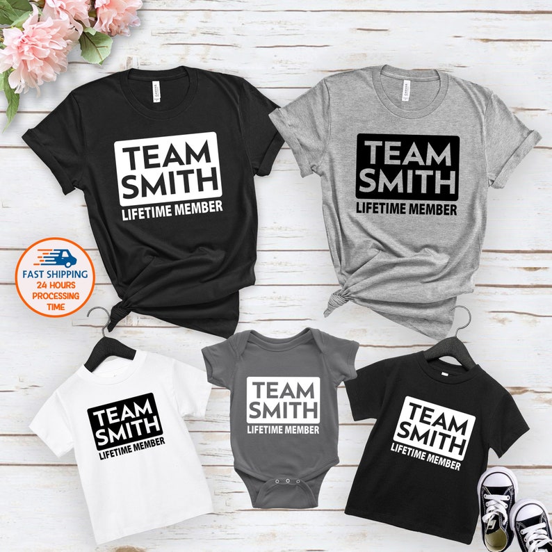 May include: Set of four t-shirts with the text "Team Smith Lifetime Member" in a white square on a black, gray, and white background.
