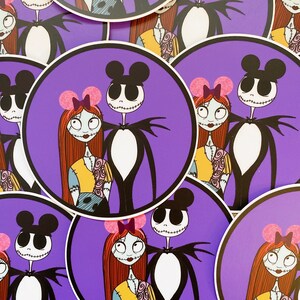 May include: A set of four round stickers featuring a purple background with a cartoon couple. The couple is dressed in black and white with pink bows. The characters are inspired by the Disney characters Jack Skellington and Sally from the movie The Nightmare Before Christmas.