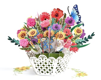 May include: A 3D pop-up card featuring a bouquet of colorful flowers in a white basket with a lace design. The flowers include sunflowers, roses, daisies, and poppies. A blue butterfly is perched on the top of the bouquet.