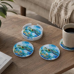 May include: A set of round drink coasters featuring a vibrant underwater scene with a sea turtle swimming over a coral reef. The set includes a white circular holder and individual coasters, one of which supports a beige ceramic coffee mug.