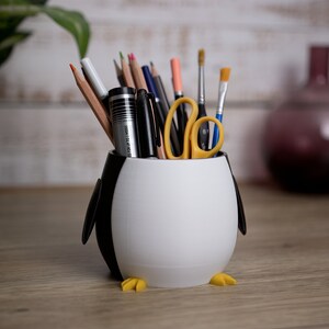 Transform your workspace with our 3D printed Penguin Pen Holder Pots. Functional and fun, they are perfect for organizing utensils and making memorable gifts.