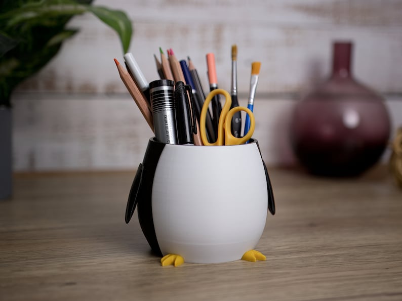 Transform your workspace with our 3D printed Penguin Pen Holder Pots. Functional and fun, they are perfect for organizing utensils and making memorable gifts.