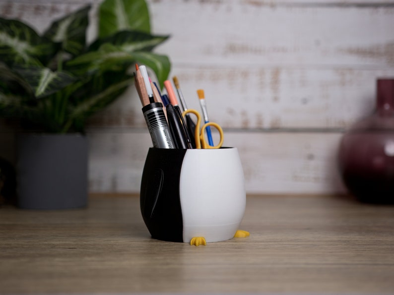 Brighten your workspace with our 3D printed Penguin Pen Holder Pots. Perfect for organizing pens and markers, they also make a unique gift for any occasion.