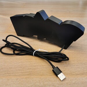 May include: Black USB-powered light shaped like the word "WOO!" with a black braided cord.