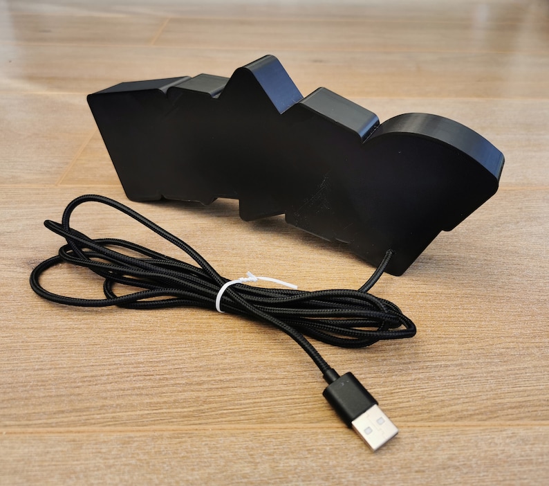 May include: Black USB-powered light shaped like the word "WOO!" with a black braided cord.