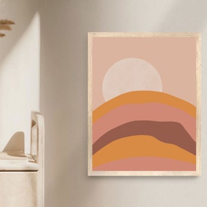 May include: Abstract art print with a pink, orange, and brown color scheme. The print features a large white circle in the center and a series of curved lines that resemble hills.