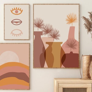 May include: Three abstract art prints with a minimalist design featuring geometric shapes and muted colors. The prints are framed in natural wood and hung on a white wall.