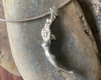 Woman Reaching for A Star Pendant