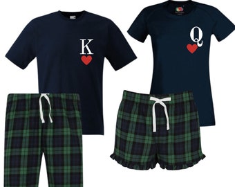 May include: A matching set of pajamas with a navy blue t-shirt and green and black plaid shorts. The t-shirt has a white letter "K" and a red heart. The shorts have a white drawstring.