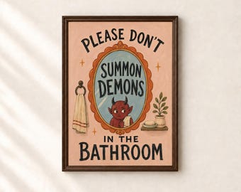 May include: A framed wall art print with a light pink background featuring the text 'PLEASE DON'T SUMMON DEMONS IN THE BATHROOM'. An oval mirror reflects a red horned creature, with a hanging towel and a small potted plant nearby.