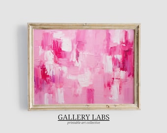 May include: An abstract painting featuring thick, textured brushstrokes in various shades of pink, magenta, and white, enclosed within a light-toned wooden frame. The artwork displays a layered composition of vibrant colors and visible paint texture.