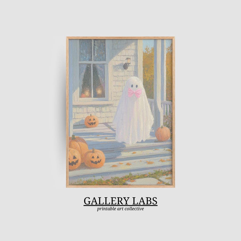 May include: A framed art print featuring a white ghost wearing a pink bow standing on a porch with orange jack-o'-lanterns. The scene depicts a house exterior with a window and autumn leaves. Below the image, the text reads GALLERY LABS printable art collective.