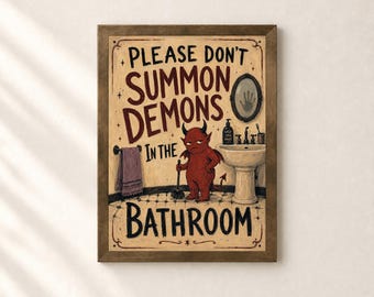 May include: A framed wall art print featuring a red demon holding a toilet brush in a bathroom setting. The text reads, "PLEASE DON'T SUMMON DEMONS IN THE BATHROOM." The illustration includes a sink, a mirror with a handprint, and a towel.
