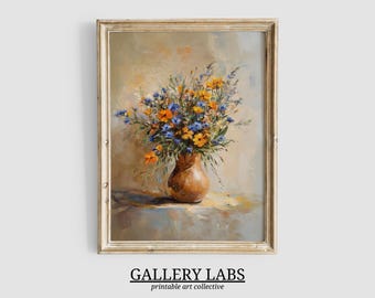 May include: A framed oil painting print featuring a bouquet of orange and blue wildflowers in a rounded brown ceramic vase. The artwork displays visible brushstrokes and a soft, neutral background. The text GALLERY LABS printable art collective appears below.