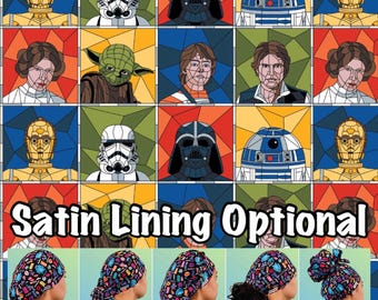 May include: A Star Wars-themed scrub cap featuring character portraits in a stained-glass style. The image displays various cap styles: Euro, Ponytail, Bouffant, Tie Back, and High Bun. Text reads "Satin Lining Optional."