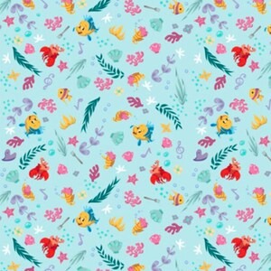 May include: A light blue fabric pattern featuring repeating illustrations of yellow fish, red crabs, pink coral, green seaweed, seashells, musical notes, and silver forks scattered across the surface in a colourful underwater-themed design.