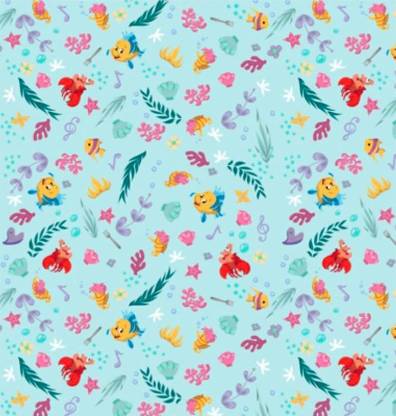 May include: A light blue fabric pattern featuring repeating illustrations of yellow fish, red crabs, pink coral, green seaweed, seashells, musical notes, and silver forks scattered across the surface in a colourful underwater-themed design.