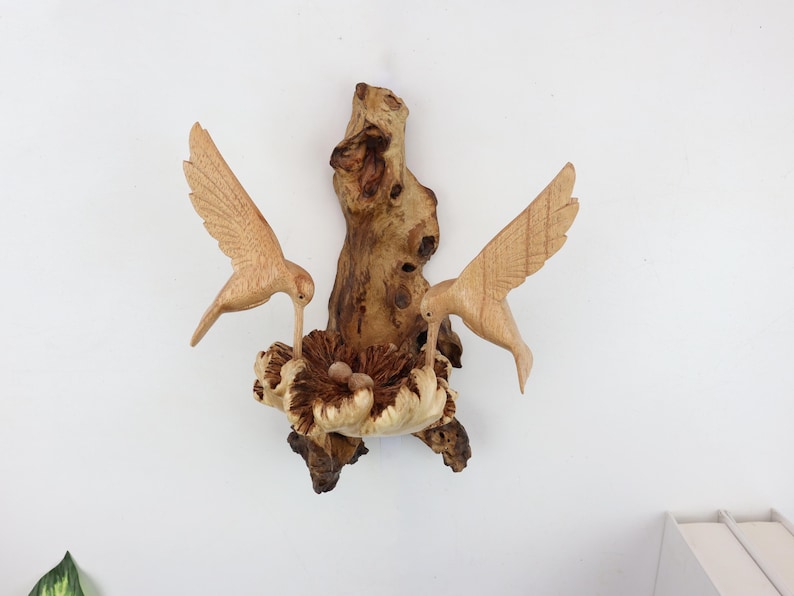 Hand carved wooden double hummingbird wall art on natural wood base.