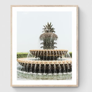May include: A large, ornate fountain shaped like a pineapple with cascading water. The fountain is made of stone and has a bronze finish. The water flows from the top of the pineapple and down the sides, creating a beautiful display.