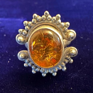 Vintage handmade sterling silver and amber ring with pretty sunshine design setting.