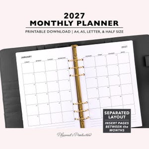 May include: A 2027 monthly planner with a black leather-textured binder and gold-toned six-ring mechanism. The open white pages display a January calendar grid with days of the week, a notes column, and text stating Separated Layout Insert Pages.