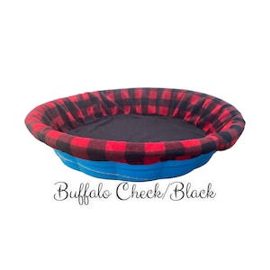 May include: A blue pie pan with a red and black buffalo check fabric lining. The text "Buffalo Check/Black" is written below the pan.