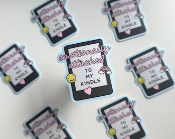 Puede incluir: Seis pegatinas azules y rosas con el texto "emocionalmente apegado a mi kindle" y un arcoíris, una carita sonriente y un corazón.