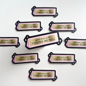 May include: Nine pink and black stickers with gold lettering that reads "your email is not finding me well".