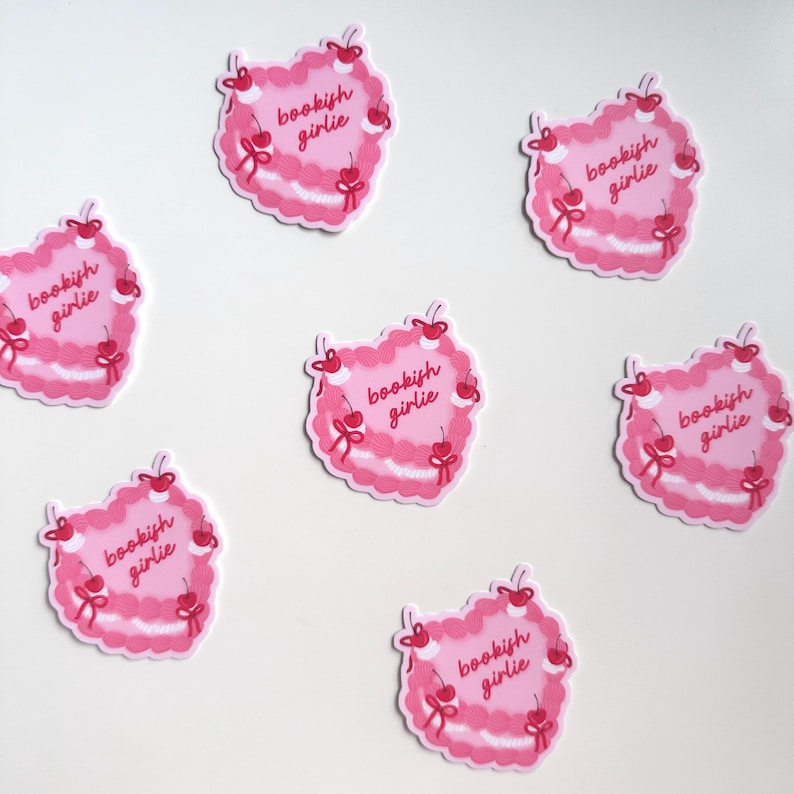 May include: Six pink heart-shaped stickers with the text "bookish girlie" and red cherries around the edge.