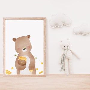 May include: A brown bear holding a honey pot in its paw, surrounded by bees and honeycomb. The bear is looking at the viewer. The image is in a white frame.