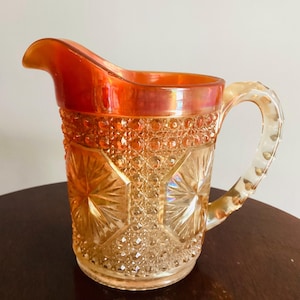 Imperial Star Medallion Carnival Glass pitcher in marigold. Calrnival Glass Pitcher, Orange Vintage Pitcher, Vimtage glass Pitcher